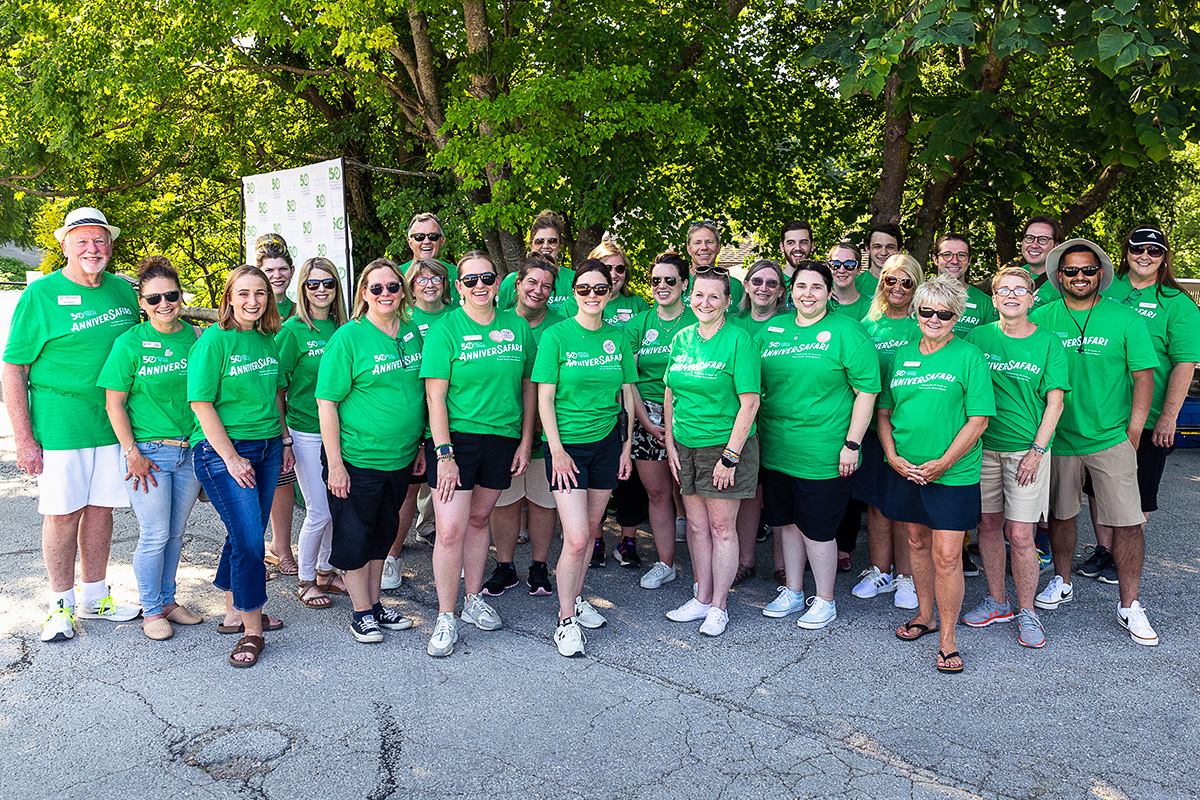 A large group of people, all wearing green t-shirts that say ANNIVERSAFARI.