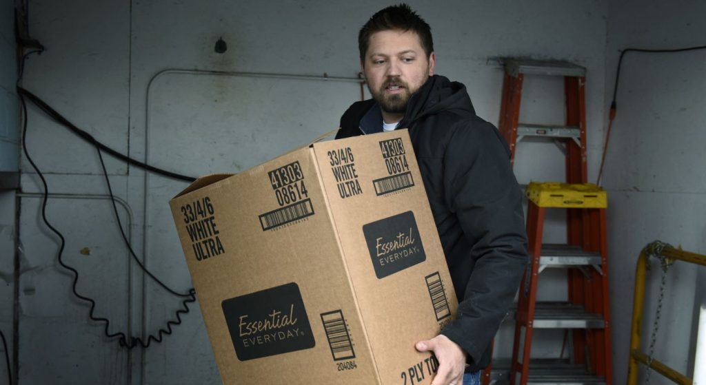 North Dakota, Man unloading boxes, Bush Foundation