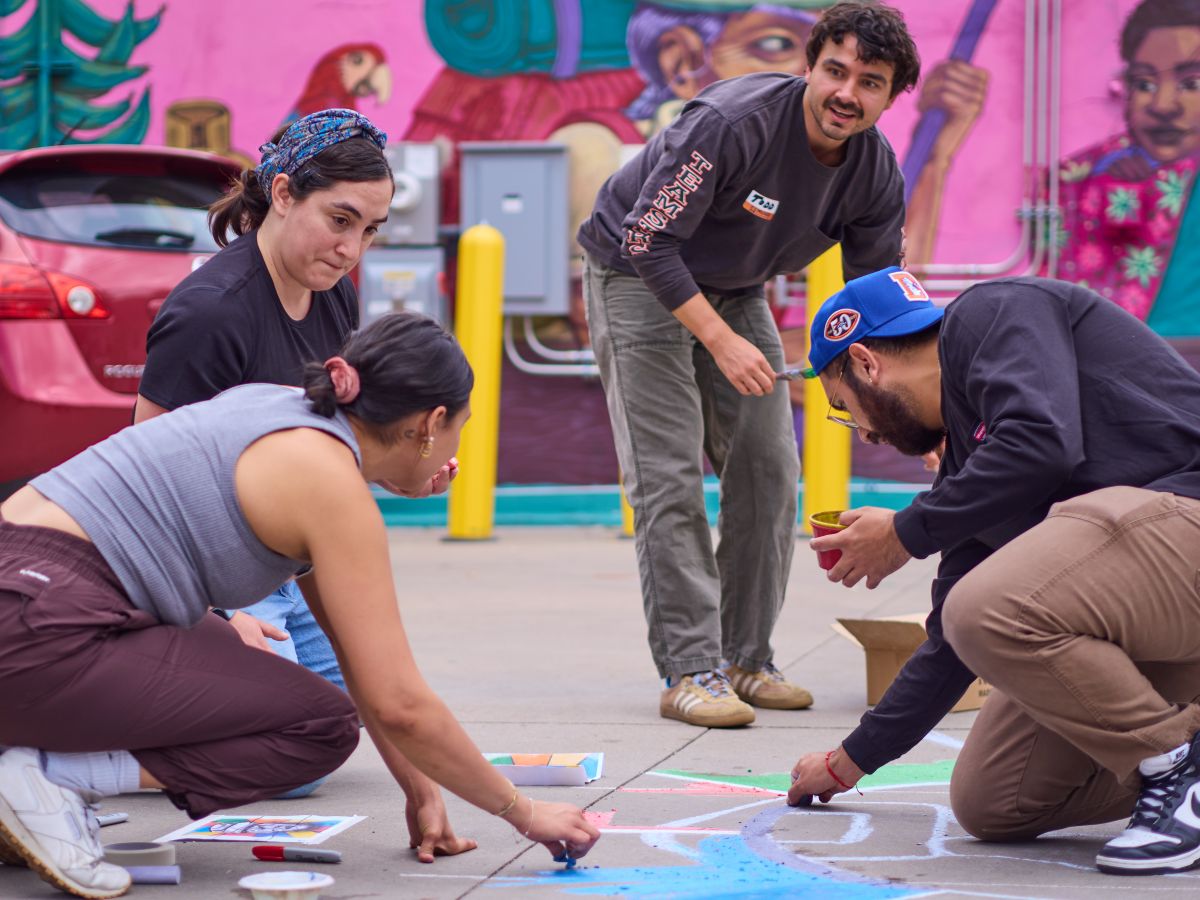 Participants in a chalk mural for Museo de Las Americas, The Denver Foundation