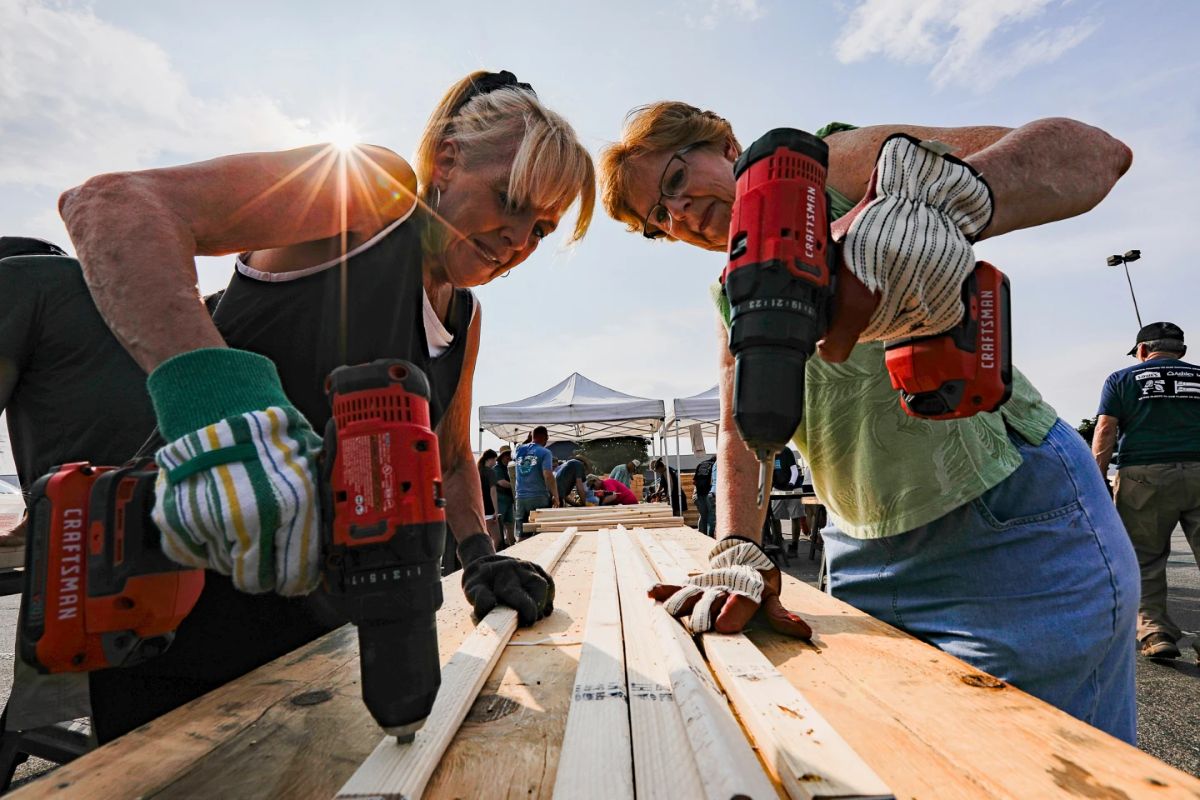  Volunteers Susan Chastain and Jenny Allen drill holes into two-by-fours during Bunks Across America, a non-prot event to build bunk beds for children in need at Lowe’s, June 12, 2021 in East Brainerd, Tenn. (Troy Stolt/Chattanooga Times Free Press via AP, File)