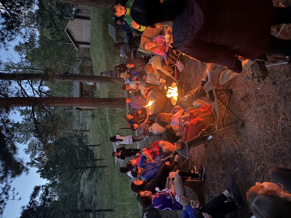 Outdoor Unidos, group around a warm campfire