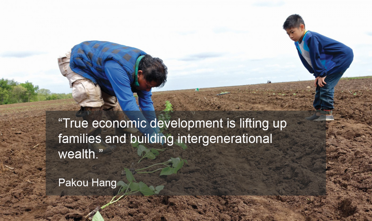 A picture of a man and a young boy working in a field, with the following quote from Pakou Hang on top: “True economic development is lifting up families and building intergenerational wealth.”