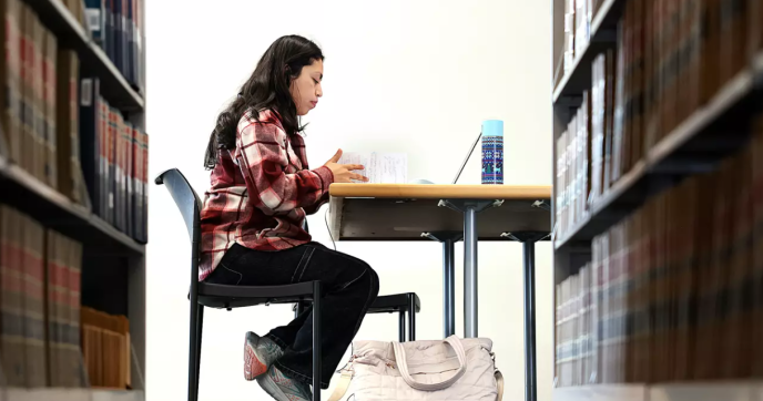 Adriana Orea studies for classes inside a library at Los Angeles City College. Photo by Christina House