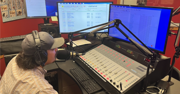 A DJ on air at KOJB in northern Minnesota, the Leech Lake Nation’s premier radio station.