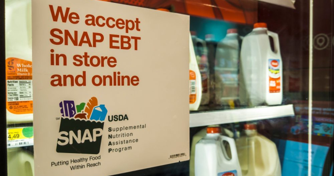 Paper sign on grocery fridge "We accept SNAP EBT in store and online" Credit: rblfmr/Shutterstock